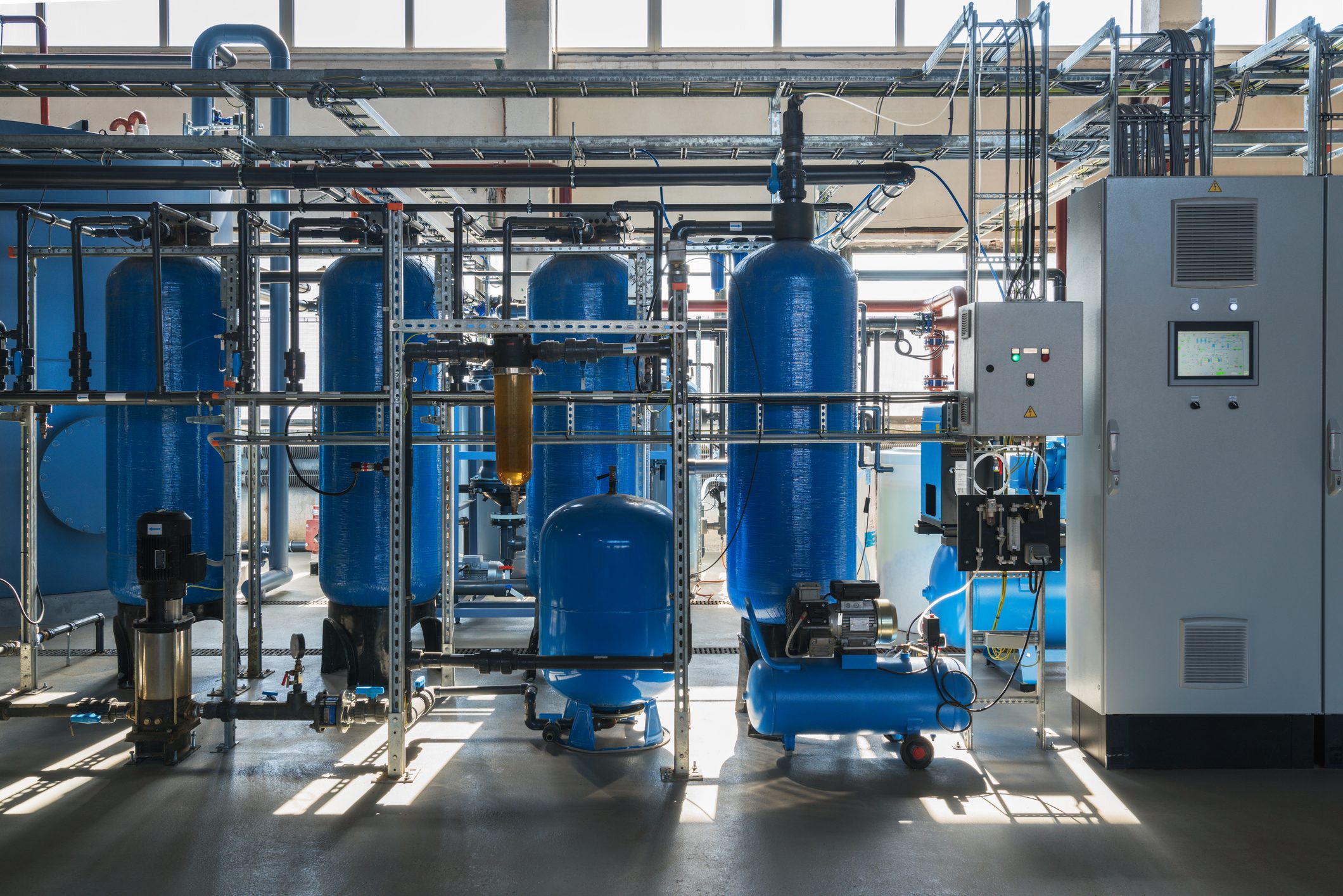 Industrial machinery with blue tanks and pipes.