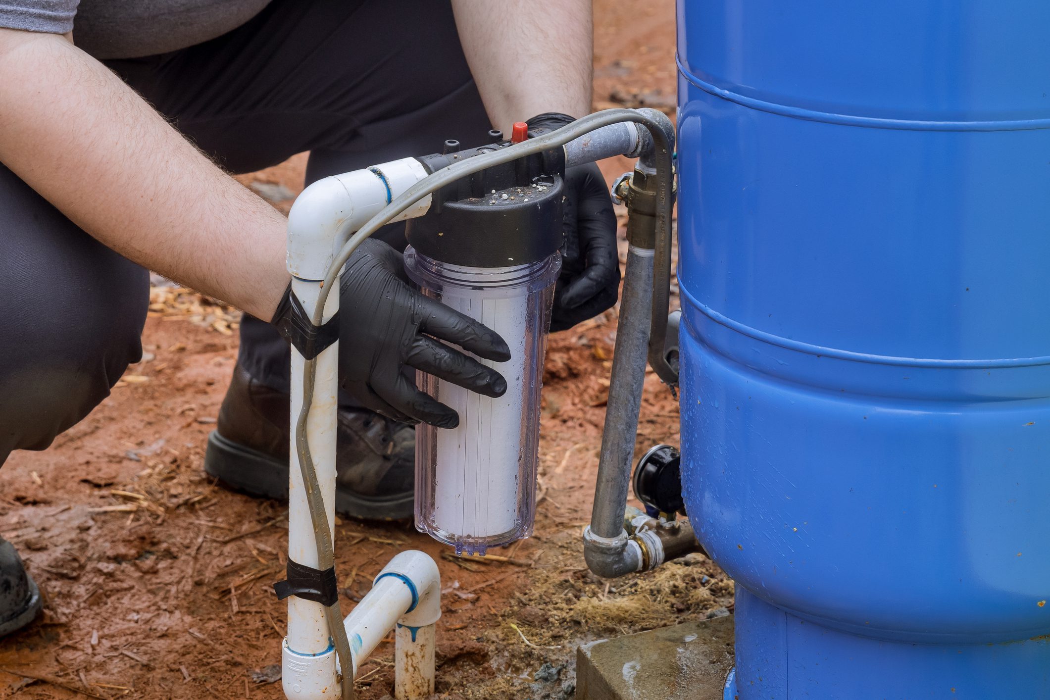 Man installing a water filtration system.